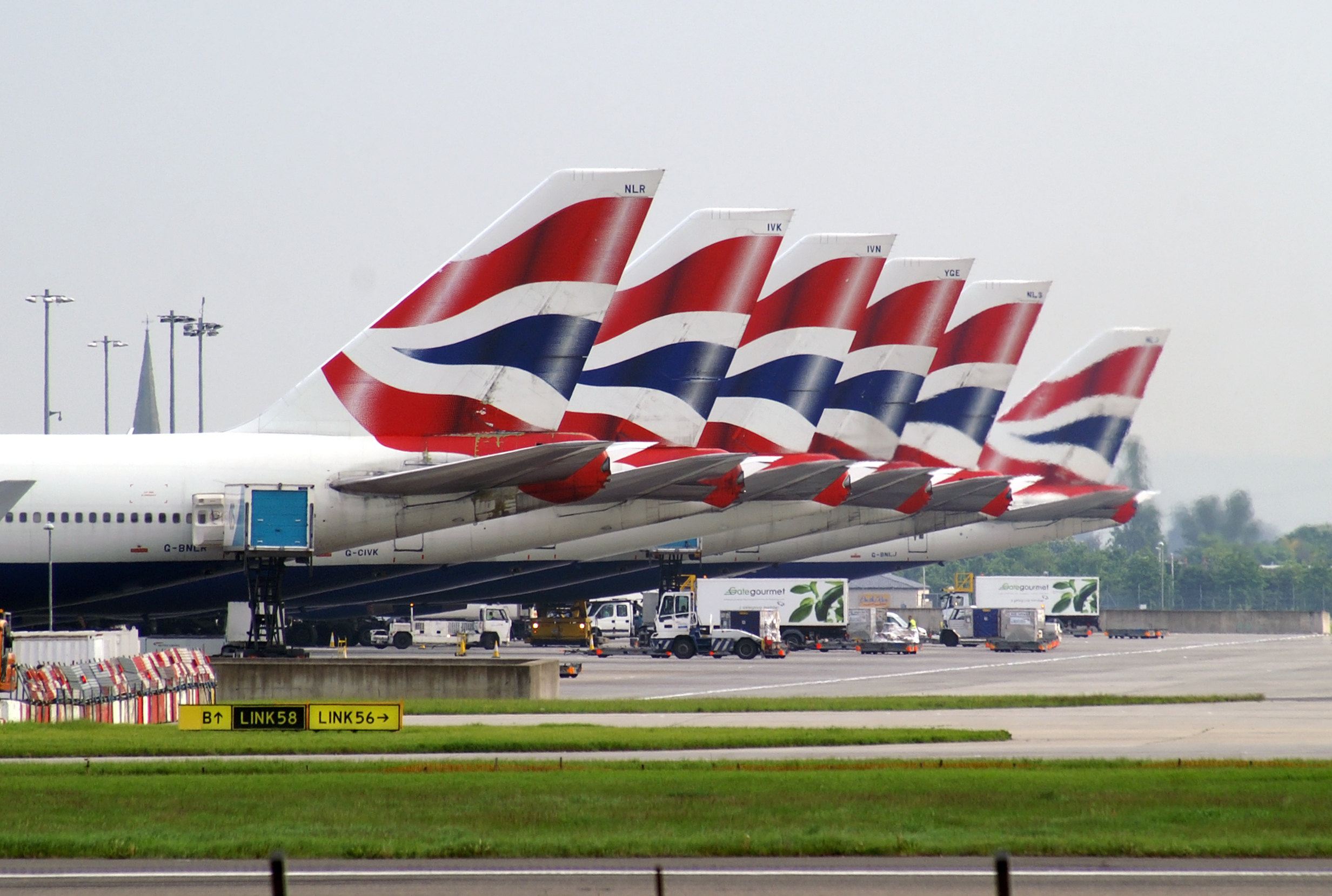 The tail end of a small selection of British airways fleet. All of which carry the Union Jack