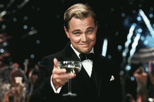 Leonardo DiCaprio prostet dem Betrachter mit einem Cocktail zu